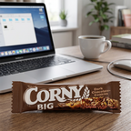 Corny Big Dark Chocolate-Cookies ved kaffekop på kontorbord