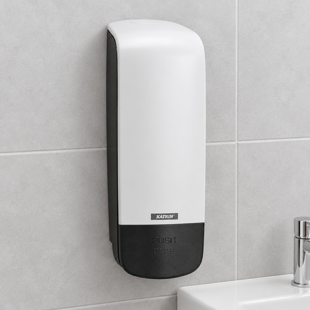 Hvid Katrin 77373-dispenser ved grå fliser og håndvask
