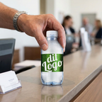 Voksen arrangør placerer logovand med grøn eksempeletiket på receptionsbord