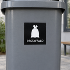 Nærbillede af sort restaffaldsmærke med hvidt pose-symbol