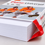 Nærbillede af hvide papirkanter og åbnet Plano Universal-emballage, stemningsillustration
