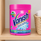 Vanish Pink Powder i pink bøtte på træhylde ved kurv