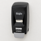 Sort GOJO Hand Medic-dispenser på lys væg